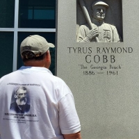 Examining a Ty Cobb monument.